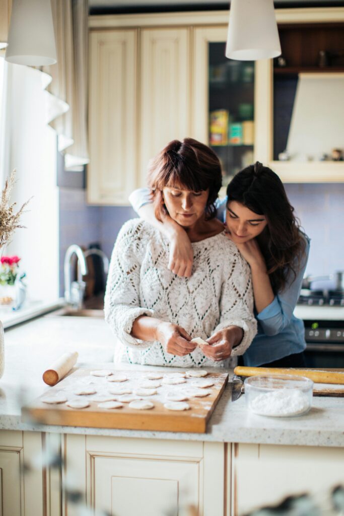 pexels-photo-3893532-3893532 A mother and daughter bond while preparing traditional dumplings in a cozy kitchen setting.